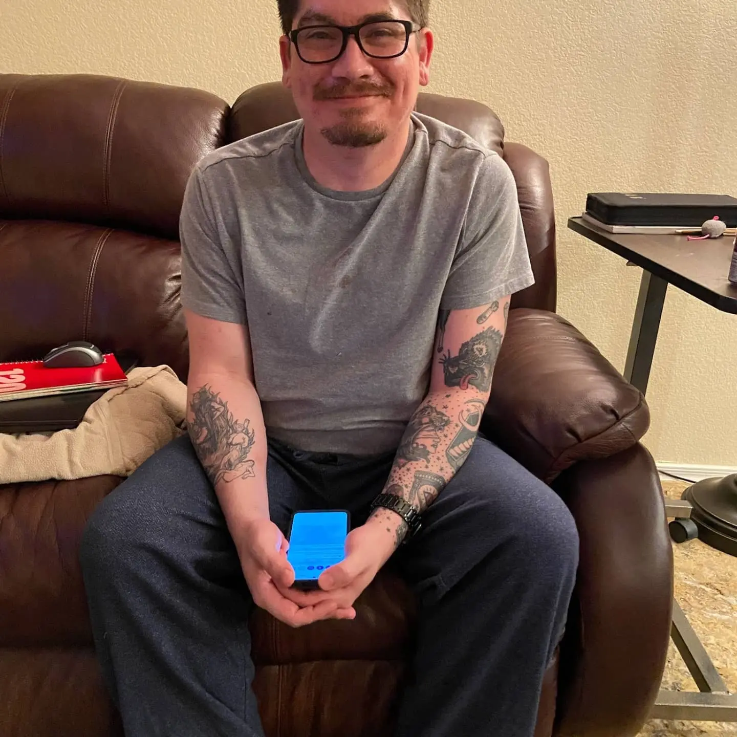 Gabe sitting with his phone